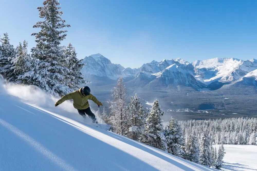 Original snowboard powder photo on a sunlit slope.